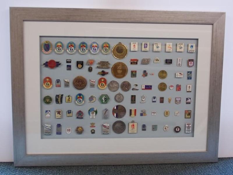 A large collection of medals and pin badges collected over 40 years by a well known sports presenter.